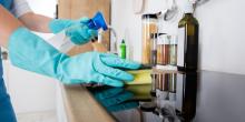 Domestic cleaner cleaning kitchen worktop